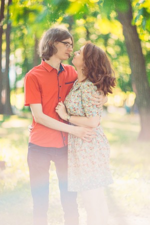 Beautiful young couple on the park backgroundの写真素材