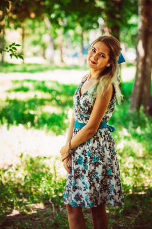 Young beautiful girl in floral dressの写真素材