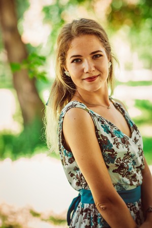 Young beautiful girl in floral dressの写真素材
