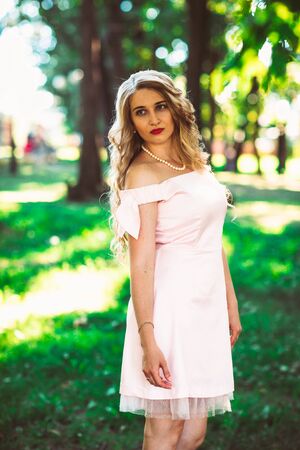 beautiful girl blonde on nature backgroundの写真素材