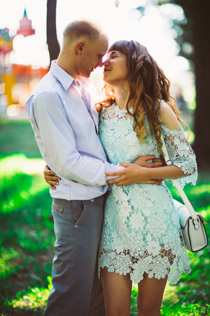 Beautiful young couple on the park backgroundの写真素材