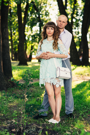 Beautiful young couple on the park backgroundの写真素材