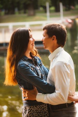 Beautiful young couple on the lake backgroundの写真素材
