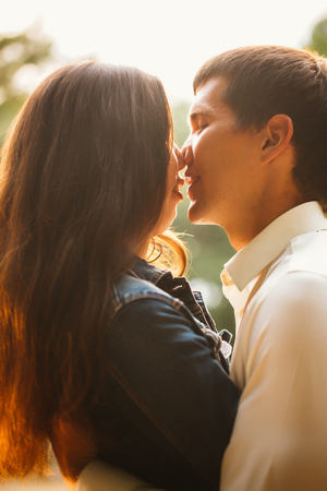 Beautiful young couple on the lake backgroundの写真素材