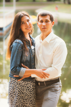 Beautiful young couple on the lake backgroundの写真素材