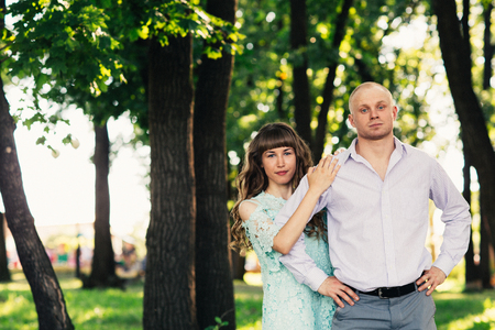 Beautiful young couple on the park backgroundの写真素材