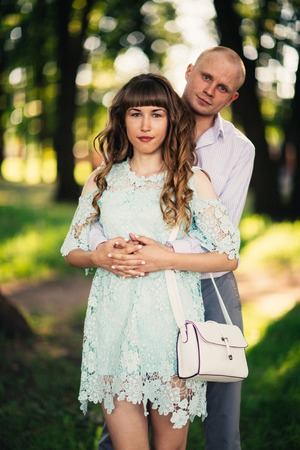 Beautiful young couple on the park backgroundの写真素材