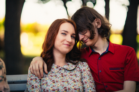 Beautiful young couple on the park backgroundの写真素材