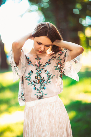 Beautiful young girl on a nature backgroundの写真素材