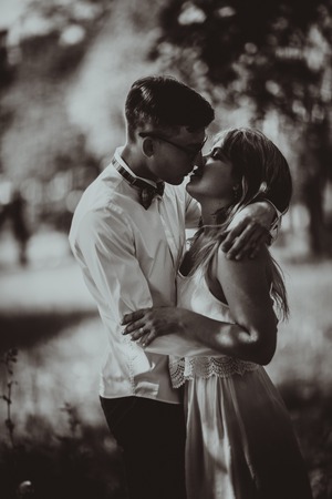 Black and white photo Young beautiful couple on a blurred natural backgroundの写真素材