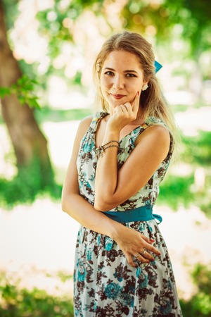 Young beautiful girl in floral dressの写真素材