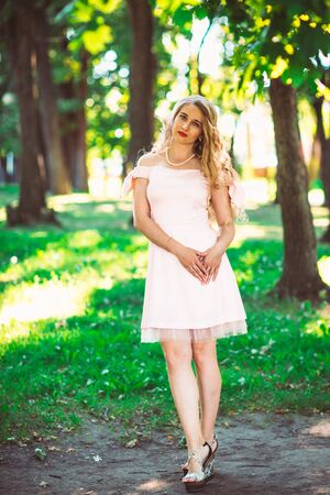 beautiful girl blonde on nature backgroundの写真素材