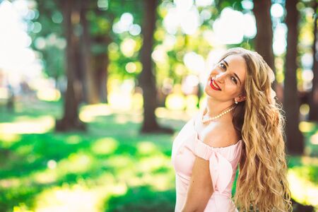 beautiful girl blonde on nature backgroundの写真素材