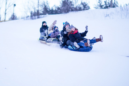 People slide down from the snow hillの写真素材