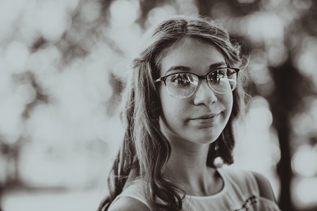 Beautiful young girl on natural backgroundの写真素材