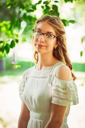 Beautiful young girl on natural backgroundの写真素材