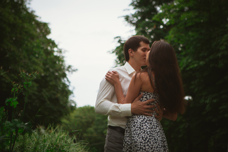 Beautiful young couple on a nature backgroundの写真素材