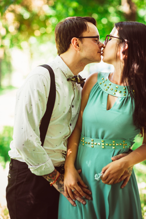 Beautiful young couple on the park backgroundの写真素材