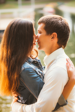 Beautiful young couple on the lake backgroundの写真素材