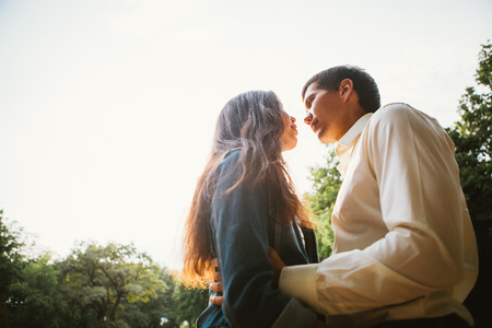 Beautiful young couple on the sunset backgroundの写真素材