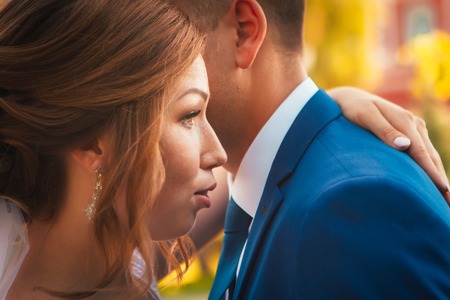 couple groom and bride hugging and kissing on nature park backgroundの写真素材