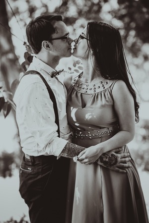 Beautiful young couple on the park backgroundの写真素材