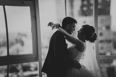 black white photo bride and groom on background clear windowsの写真素材