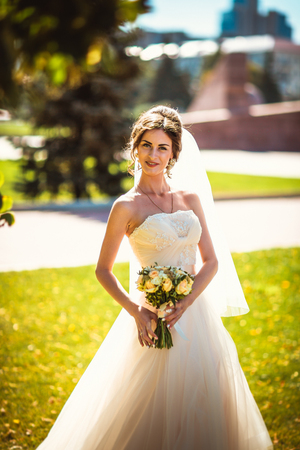 The beautiful brunette bride on a walk in parkの写真素材