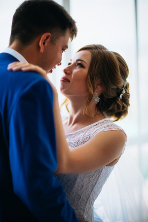 bride and groom on background clear windowsの写真素材