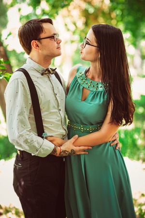 Beautiful young couple on the park backgroundの写真素材