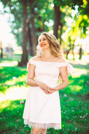 beautiful girl blonde on nature backgroundの写真素材