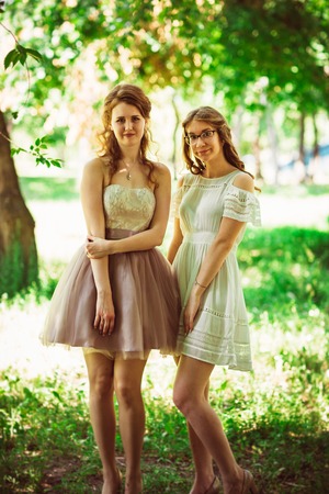 Two beautiful girlfriends at the nature backgroundの写真素材