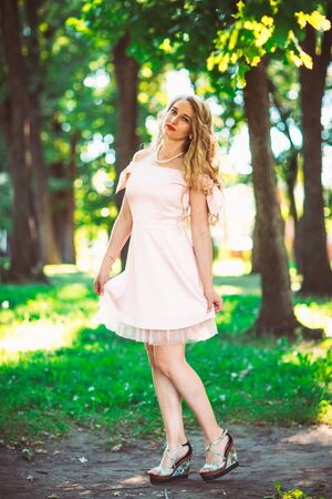 beautiful girl blonde on nature backgroundの写真素材
