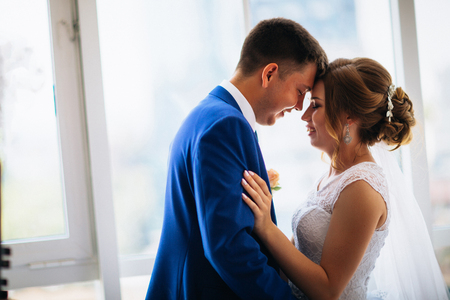 bride and groom on background clear windowsの写真素材