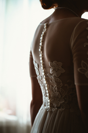 Portrait of a beautiful young bride near the window.の写真素材