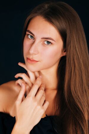 Portrait beautiful girl on a dark studio backgroundの写真素材