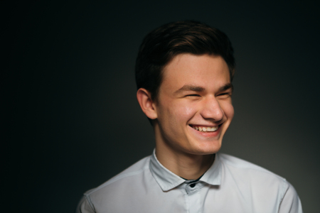 young brunette guy in a white shirtの写真素材