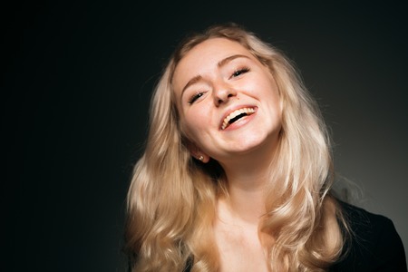 young girl blonde on a dark backgroundの写真素材
