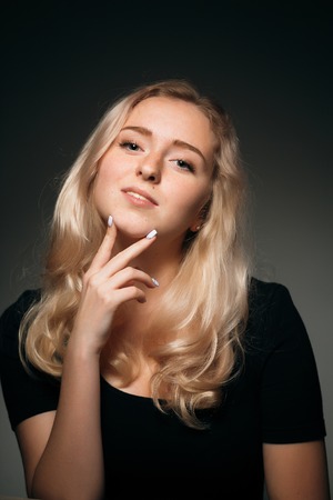 young girl blonde on a dark backgroundの写真素材