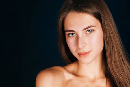 Portrait beautiful girl on a dark studio backgroundの写真素材