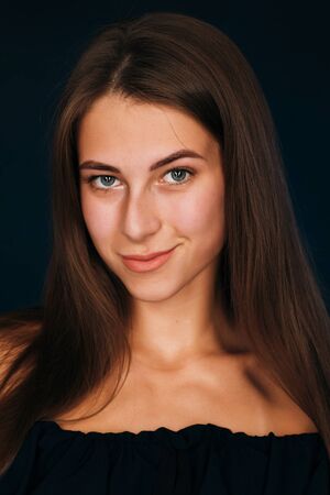 Portrait beautiful girl on a dark studio backgroundの写真素材