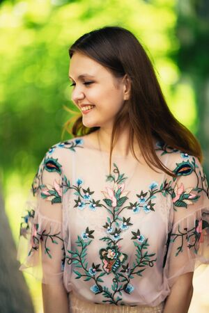 Beautiful young girl on a nature backgroundの写真素材