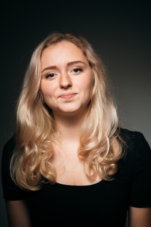 young girl blonde on a dark backgroundの写真素材