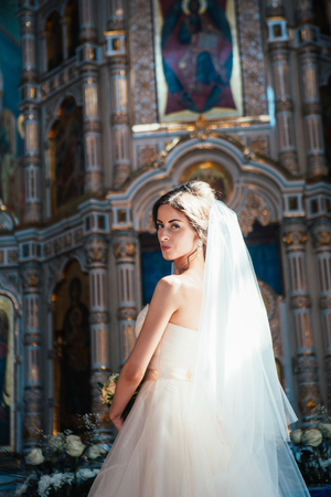 Stylish elegant bride on background the old churchの写真素材