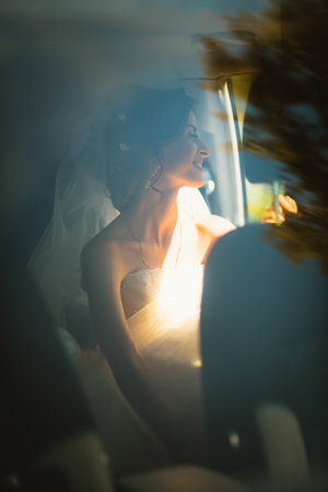 portrait of a young bride in a car windowの写真素材