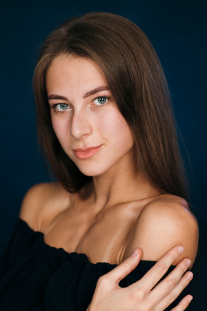 Portrait beautiful girl on a dark studio backgroundの写真素材
