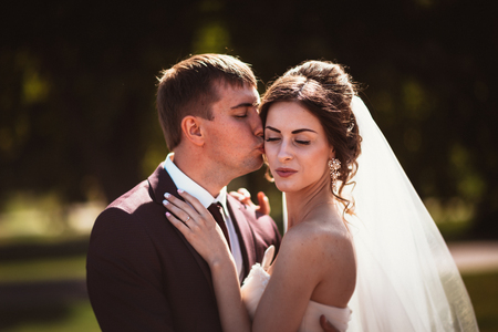 young couple groom and the bride on the park background.の写真素材