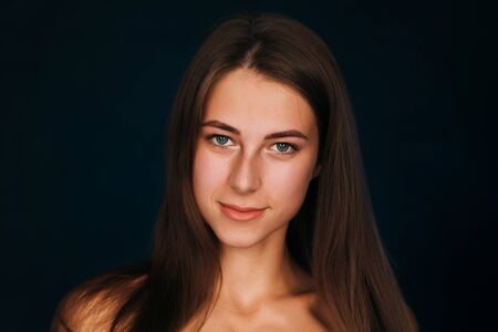 Portrait beautiful girl on a dark studio backgroundの写真素材