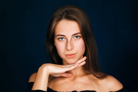 Portrait beautiful girl on a dark studio backgroundの写真素材