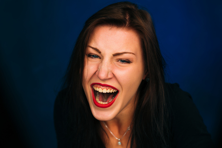 Emotional cry girl on a dark backgroundの写真素材